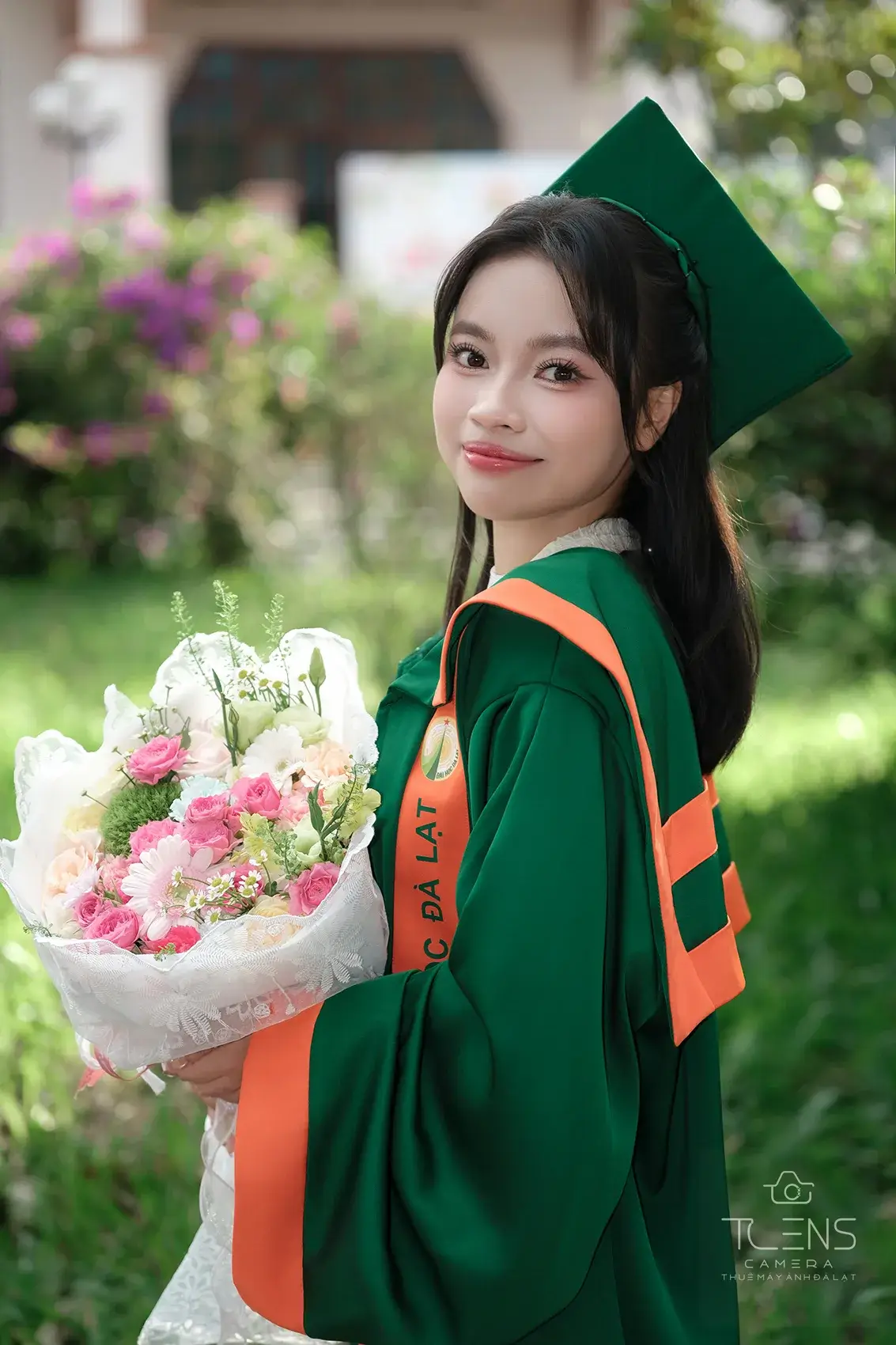 Chân dung một phụ nữ mặc áo dài xanh cầm bó hoa hồng, chụp bằng Fujifilm X-T30 với Viltrox 56mm F1.7
